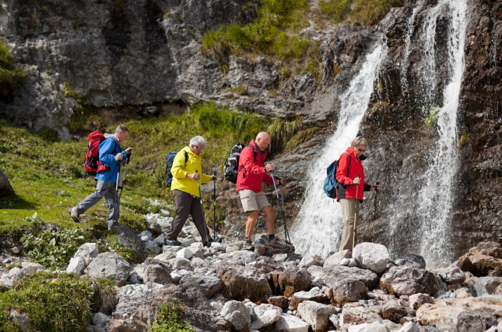 Friends hiking a waterfall