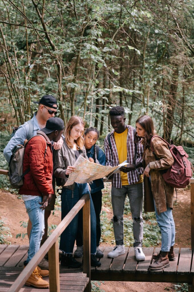 Friends using a map on a trail